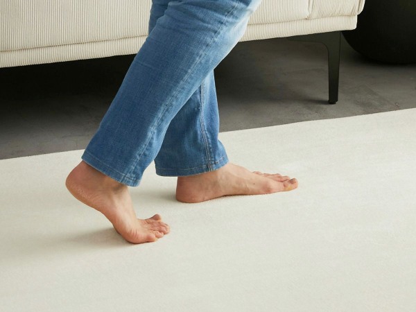 カーペットの上を歩く女性の足